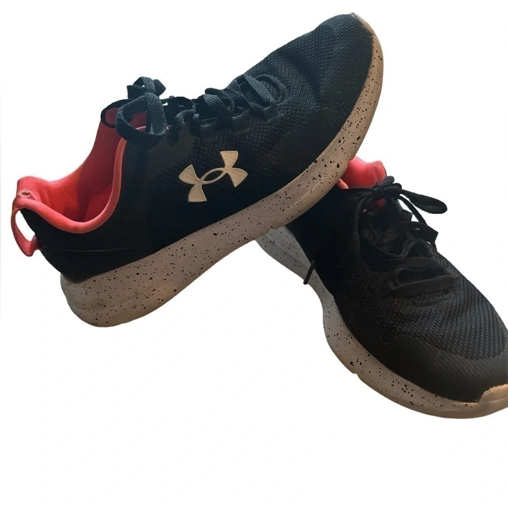 Under Armour running shoes in black and pink with paint splatter bottoms